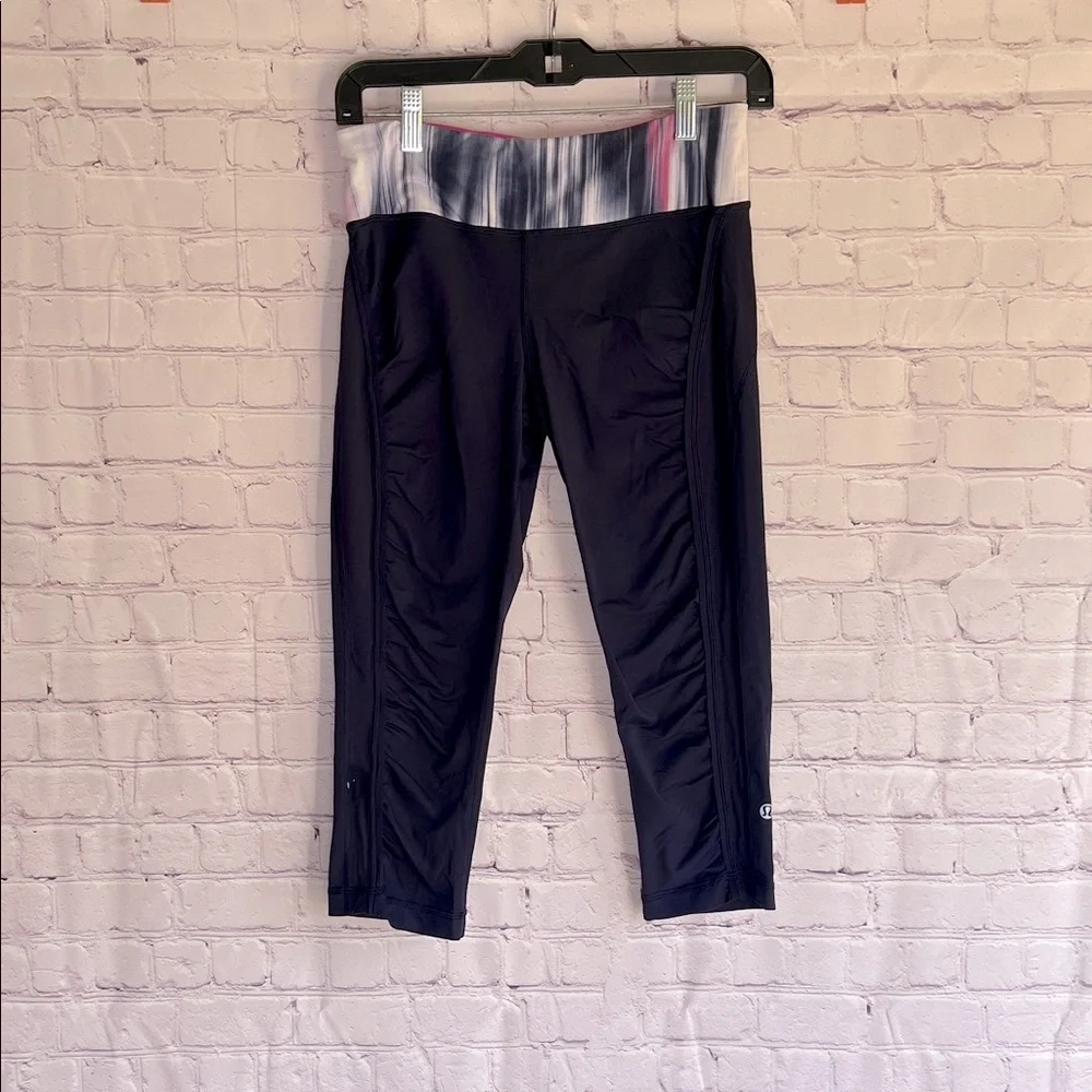 Lululemon Athletica navy blue with pink and purple Capri leggings Woman’s Size 8